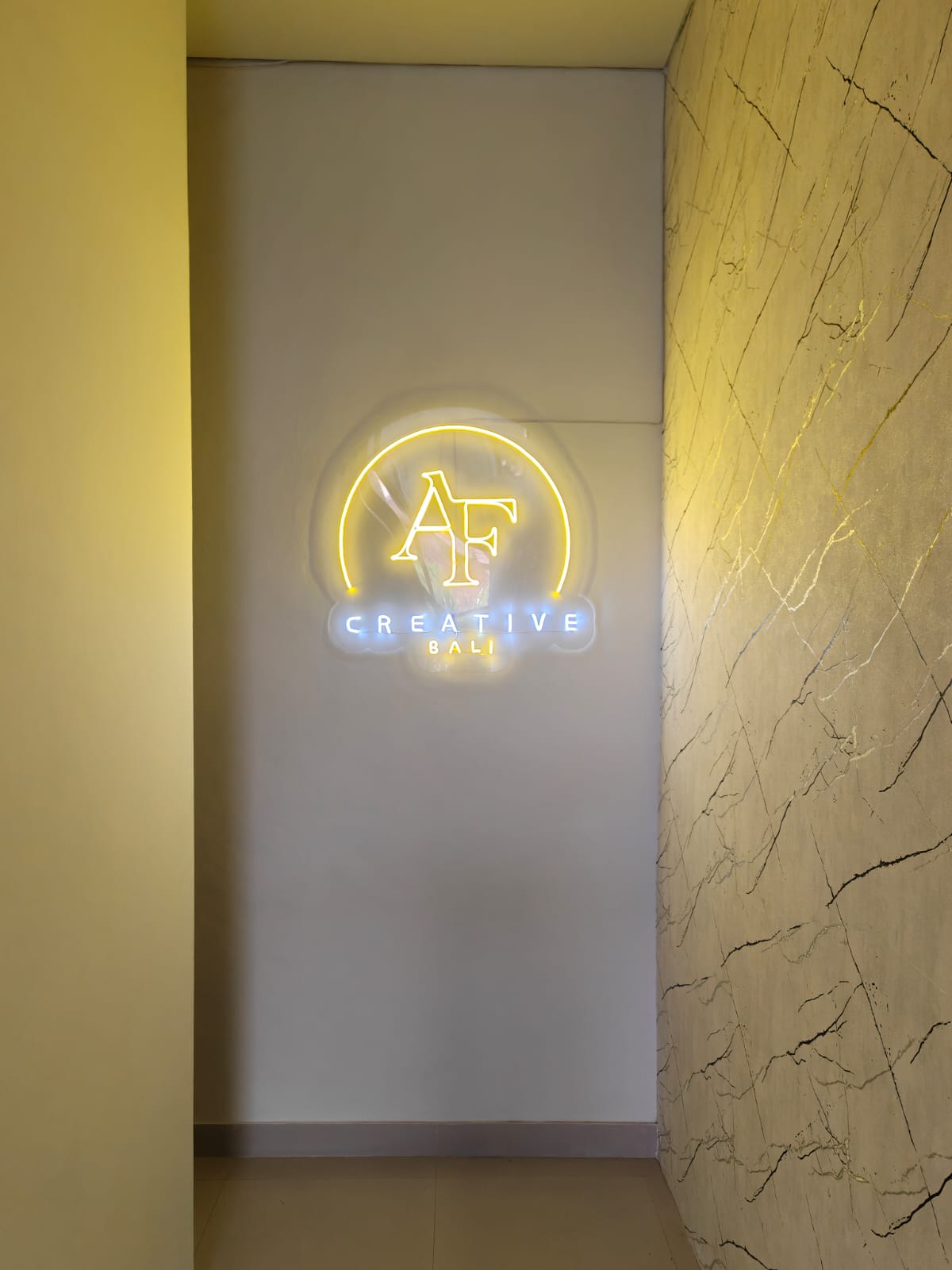 The AF Creative Bali neon sign glowing on the studio wall